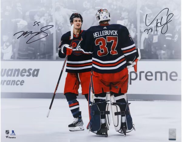 Connor Hellebuyck & Mark Scheifele Winnipeg Jets Autographed 16" x 20" Navy Alternate Jersey Celebration Spotlight Photograph